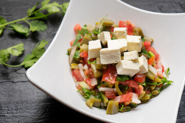 Nopal cactus salad with cheese on dark background. Mexican food