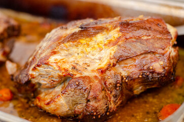 Closeup shot of appetizing cooked pork tenderloin in a baking sheet pan