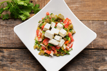 Nopal cactus salad with cheese on wooden background. Mexican food
