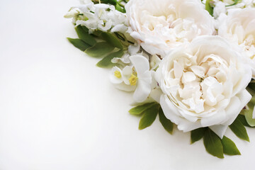 Delicate blooming festive white roses on light background, blossoming flowers soft pastel frame, bouquet floral card, selective focus