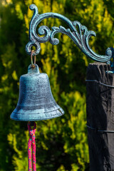 AN OLD BELL ANNOUNCES THE ARRIVAL OF VISITORS