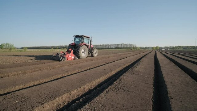 The tractor prepares the soil for planting. Agricultural machinery.