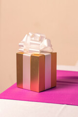 GOLDEN GIFT BOX WITH WHITE BOW