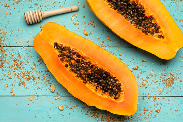 Papaya fruit half on turquoise background