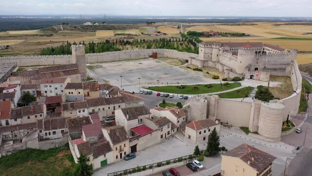 Aerial view of ancient Castle of Dukes of Alburquerque on background with Cuellar cityscape in summer day, Spain