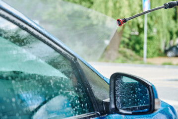 Car washing. Cleaning car with contactless high pressure washing. Self wash station