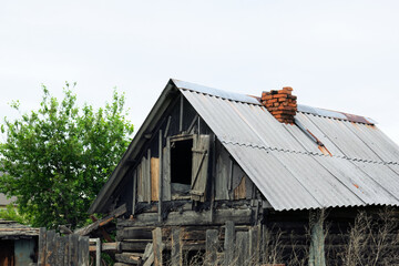 The old  abandoned hut in the village. Wreckage of an old destroyed wooden house, demolition