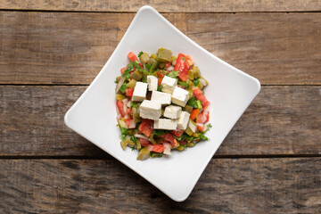 Nopal cactus salad with cheese on wooden background. Mexican food