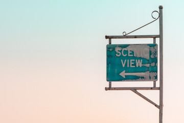 weathered blue Scenic View sign with arrow old open space