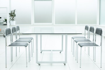 Laptop on glass table in spacious office space