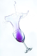 A splash of blue water in a glass.