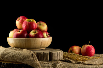 Close up Apples in a wooden bowl on black background