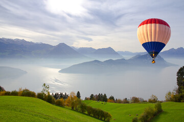 Aerial view of hot air balloon flying over Mount Rigi. Scenic view of fog over the lake at Mount...
