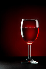 Glass of red wine on dark background