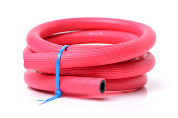 plastic red rolled up hose on white background