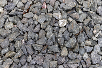 Close up rough stone background. Small rock texture.