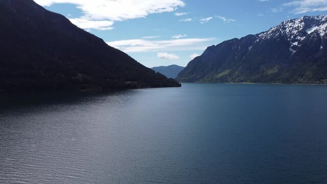 Amazing view of lake and mountains during a sunrise. Achen lake in Tyrol, Austria. Drone, aerial view of water surrounded by big Alps.