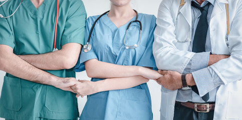 Group of Doctors With Stethoscope in Medical Uniform Holding Hands Together Posing Against Isolated Background, Physician Doctors in Patient Clinic Hospital. Doctor Occupation/Medicine Healthcare