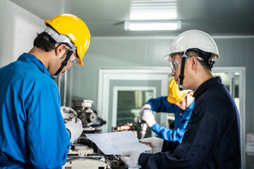 Asian technician mechanical worker work on milling machine in factory.