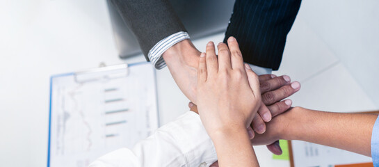 Group of businesspeople brainstorm and stack hands put palms together	
