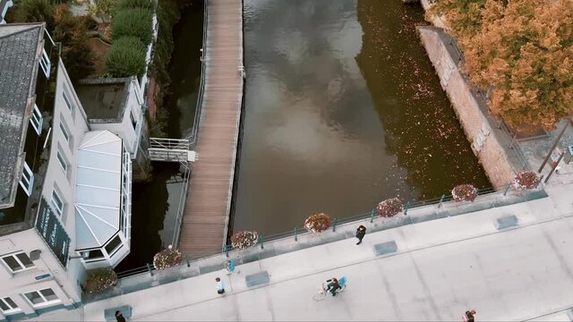 Pedestrians crossing famous Hoogbrug, Mechelen Oldest stone bridge, Belgium - Aerial