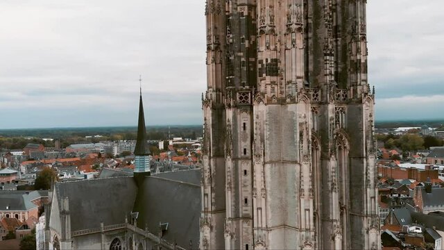St. Rumbold's Cathedral Tower revealing Mechelen Flemish Flags - Aerial Crane up