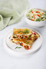 Stuffed omlette with sweet pepper, mushrooms, ham and cheese.