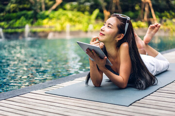 Portrait of smiling happy beauty asian freelancer traveler blogger woman relax using and work...