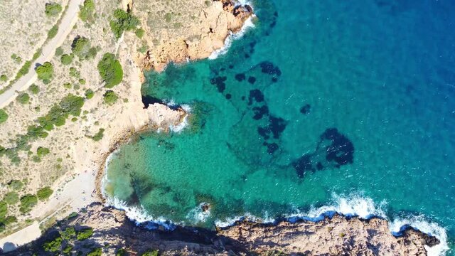 Aerial View Of Cala Tio Ximo Beach With Crystal Clear Blue Water At Daytime In Alicante, Spain.