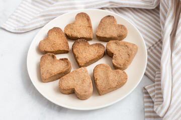 homemade heart-shaped cookies on a plate, Valentine's day gift with love, gluten-free buckwheat flour pastries.