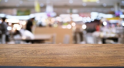 Empty wood table top and blur of night market background/selective focus .For montage product display.
