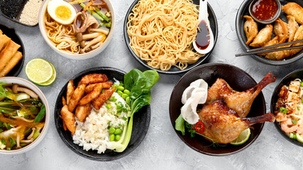 Assorted asian dishes and snacks on dark gray background. Traditional food concept.