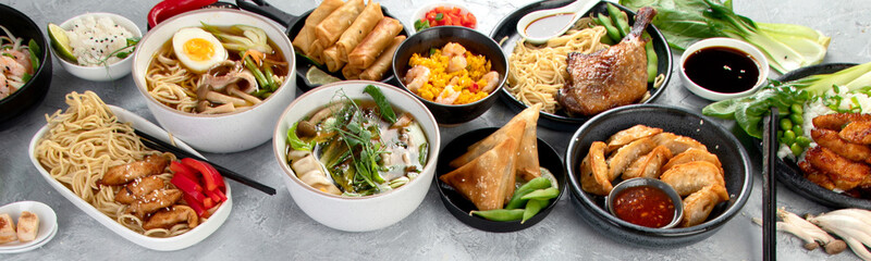 Assorted asian dishes and snacks on dark gray background. Traditional food concept.