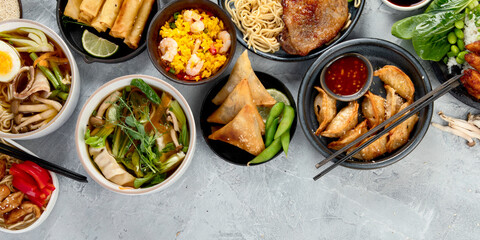 Assorted asian dishes and snacks on dark gray background. Traditional food concept.