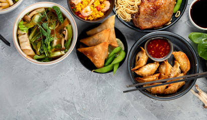 Assorted asian dishes and snacks on dark gray background. Traditional food concept.