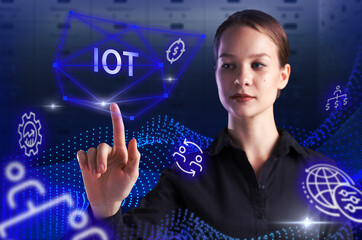 Business, Technology, Internet and network concept. Young businessman working on a virtual screen of the future and sees the inscription: IOT