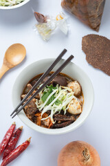 noodles with spicy pork sauce Nam ngiao on white background.Khanom Jin Nam Ngiao.