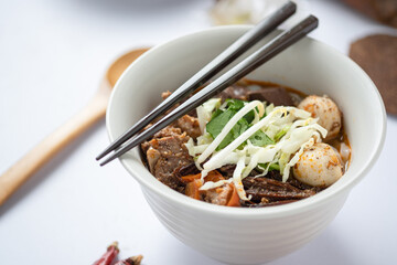 noodles with spicy pork sauce Nam ngiao on white background.Khanom Jin Nam Ngiao with copy space.