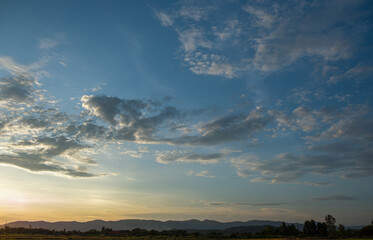 Colorful sunset and sunrise with clouds. Blue and orange color of nature. Many white clouds in the blue sky. The weather is clear today. sunset in the clouds. The sky is twilight.