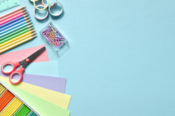 Stationery on a light blue background with space for text. Back to school. Flat lay.