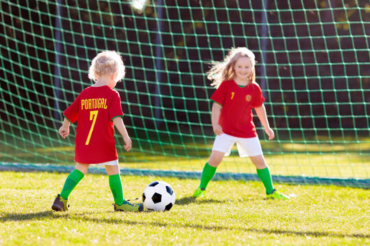 Portugal football fan kids. Children play soccer.