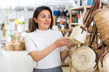 Female buyer stylish straw bag at hardware store