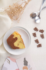 A marble cake is a cake with a streaked or mottled appearance (like marble) achieved by very lightly blending light and dark batter. It can be a mixture of vanilla and chocolate cake