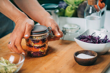 Woman Holding a Jar with Fermented Vegetables.