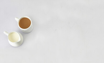 Fototapeta na wymiar top angle of Porcelain cup of tea and cup of milk isolated on white background with copy space