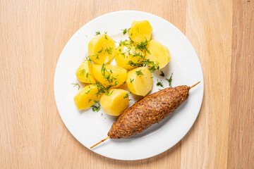 kebab with baked potato and dill