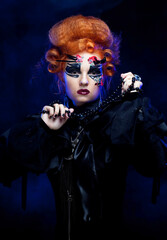 Halloween Vampire Woman portrait. Beautiful Glamour Fashion Sexy Vampire Lady with red hair.