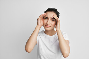 woman holding her head migraine health problems dissatisfaction
