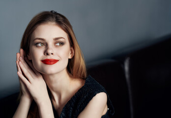 Fototapeta na wymiar attractive woman in black evening dress red lips smile cropped view studio