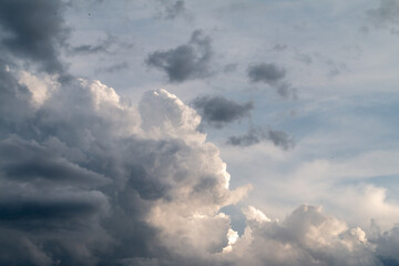 Fototapeta na wymiar fluffy stormy clouds in the sunset sky 